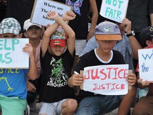 Refugee children take part in a protest in March 2015 against their resettlement on Nauru and living conditions on the island. (Amnesty International)