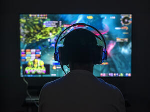 Young gamer playing video game wearing headphone (Shutterstock/File Photo)