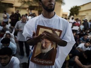 Bahraini protesters hold posters of Sheikh Qassim in June, after Bahraini authorities stripped him of his citizenship. (AFP/File)