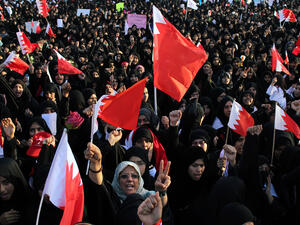 People wave Bahraini flags during a demonstration. (AFP/File)