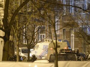 Police stand close to the suspects' apartment in the Forest district of Brussels, Belgium. (AFP/Dirk Waem)