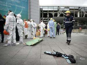 Forensic investigators gather around a blood-soaked vest outside the Brussels airport. (AFP/Yorick Jansens)