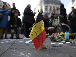 Mourners light candles and bring flowers to honor those killed in the Brussels attacks. (AFP/File)