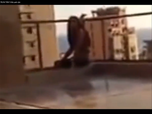 The terrifying moments before a woman throws herself off of her building. (screen grab from YouTube)