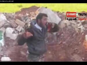 A Syrian rebel eats the heart of a dead Syrian solider.( YouTube screen-grab)