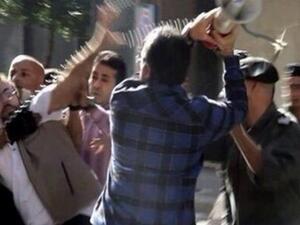 A Lebanese customs official attacks a reporter with his own bullhorn. (YouTube)