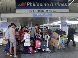 Passengers standing at the Philippine Airlines terminal at Manila International Airport on August 11, 2015. (AFP) Passengers standing at the Philippine Airlines terminal at Manila International Airport on August 11, 2015. (AFP)