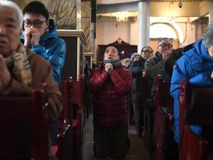 Chinese Christians pray in a state-backed church (AFP/FILE)