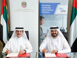 Dr. Amin Hussein Al Amiri and Mohammed Al Muallem Signing the MoU