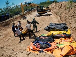 Appeal for international help as mass grave dug for 1,300 victims (Twitter)