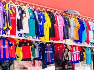 Stores in Dubai's Karama district sell counterfeit shirts for a fraction of their official retail price. (Arab News)