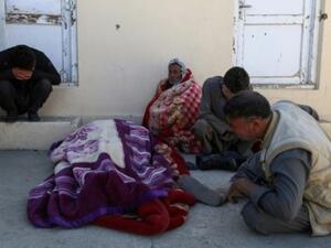 رجال أفغان متشددون قرب جثة في موقع هجوم شنه مسلحو طالبان على مجمع حكومي في منطقة خواجة العمري في إقليم غزنه الجنوبي الشرقي
