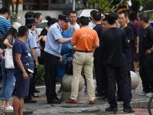 شرطي يتحدث إلى أحد المحتجين في بكين
