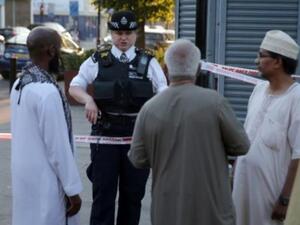 شرطية تتحدث الى مقيمين في حي فينسبوري بارك بشمال لندن بعد دهس شاحنة لمارة بالقرب من مسجد
