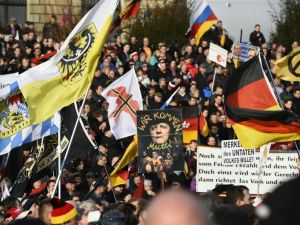 Supporters of the Pegida movement (Patriotic Europeans Against the Islamization of the Occident) hold placards featuring Angela Merkel in Dresden, eastern Germany, on February 6, 2016. (AFP/Tobias Schwarz)