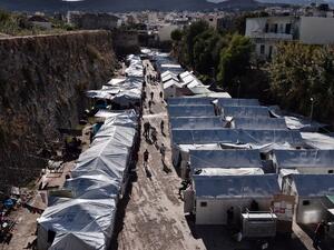 People walk at the Souda municipality-run refugee camp, on the island of Chios on October 13, 2016. (AFP/Louisa Gouliamaki)