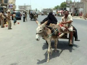 رجل وامراة على عربة يجرها حمار يعودان الى زنجبار كبرى مدن محافظة ابين جنوب اليمن بعد استعادتها من جهاديي القاعدة