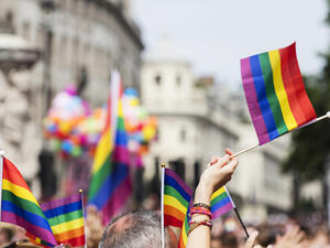 A spectator waves a gay rainbow flag at an LGBT Gay Pride march in London. (Shutterstock/ File Photo)