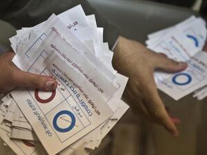 Polling station officials count ballots in the Egyptian capital Cairo on January 15, 2014. [AFP]