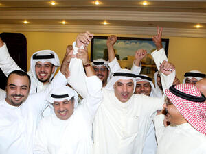 Kuwaiti candidate Faisal al-Shayaa (C) celebrates with his supporters following his victory in the parliamentary elections (AFP/YASSER AL-ZAYYAT)