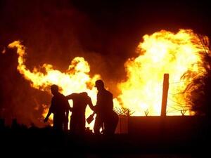 Egyptian security stand in the vicinity of flames following an attack by saboteurs on an Egyptian gas pipeline on July 12, 2011. [AFP]