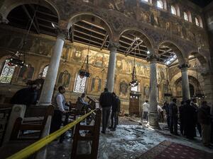 Egyptian security forces inspect the scene of a bomb explosion at the Saint Peter and Saint Paul Coptic Orthodox Church in Cairo on December 11, 2016. (AFP/Kaheld Desouki)