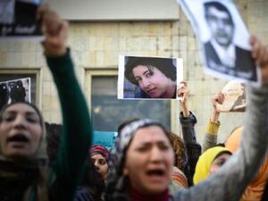 A woman holds a picture in Cairo on January 29, 2015 of Shaima al-Sabbagh during a demonstration against her killing by Egyptian police during a protest. (AFP/Mohamed al-Shahed) 