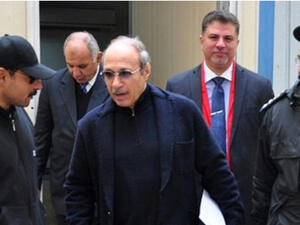 Egyptian former interior minister Habib al-Adly (c) walks outside the court room after his retrial at Cairo's police academy on February 24, 2015 (AFP)