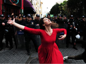 Girl in red dress dancing in front of police, a symbol of freedom from Turkey (Illustrative image) /AFP