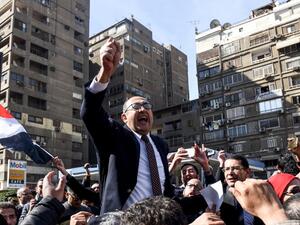 Egyptian lawyer and former presidential candidate Khaled Ali celebrates the decision amid street crowds (Mohamed El-Shahed/AFP)