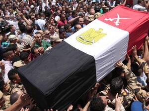 Egyptians carry the coffin of a soldier who was killed a day earlier in the restive Sinai Peninsula in an attack by ISIL, during a funeral ceremony in the 10th of Ramadan city, about 60km north of Cairo, on July 8, 2017. (Mahmoud Bakkar / AFP)