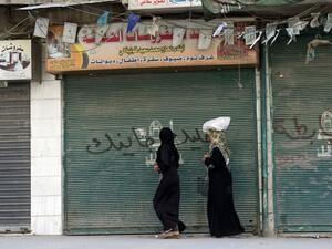 Women walk down a street in Syria's embattled Aleppo,  a former economic hub and home to priceless UNESCO-listed historical sites.  (AFP/Miguel Medina)