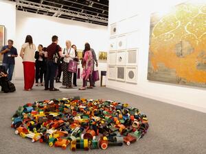 Visitors at Abu Dhabi Art 2016; a floor piece by Hussain Sharif (foreground). (Gulf News)