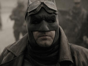 "Tell me. Do you bleed?" says Batman, whipping-out his sax. He places his lips on the mouthpiece. "You will." (Warner Bros. Entertainment, Inc.)