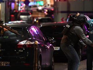 Police officers frisk a man on the Champs Elysees in Paris after the deadly shooting. (AFP)