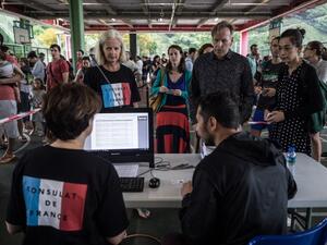 People register at a polling station during the second round of France's presidential election in Hong Kong on May 7, 2017. (AFP/Dale de la Ray)