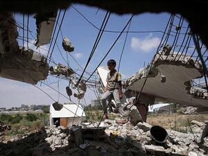 A Palestinian boy stands amid the rubble left over from Operation Protective Edge on July 8, 2015. (AFP/Said Khatib)