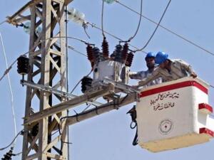 A file photo of workers conducting maintenance on a Gaza power line. (AFP/File)