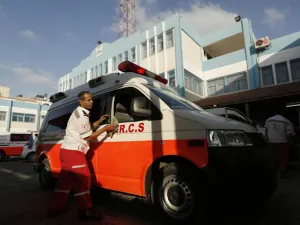 A Palestinian Red Crescent worker washes his ambulance after carrying wounded in Beit Lahia in the northern Gaza Strip. (AFP/ File)