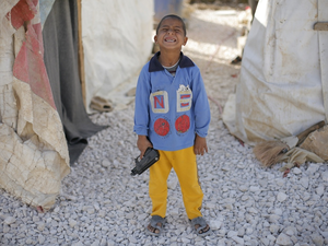 A boy plays with his toy gun at a Syrian refugee camp in Lebanon's Bekaa Valley.  (AFP/Matthieu Alexandre)