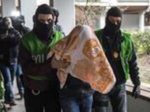 Police officers escort a man who was arrested in a flat during a raid on February 4, 2016 in Berlin. (AFP/Odd Andersen)