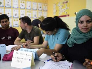 Refugees attend a German course in a classroom at a temporary home providing assistance for refugees in Berlin's Gatow district. (AFP/ TOBIAS SCHWARZ)