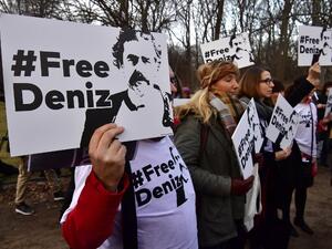 People hold placards with hashtag #FREEDENIZ to protest the detantion of German journalist Deniz Yucel in front of Turkish embassy in Berlin on February 28, 2017. (AFP/John MacDougall)