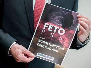 Lower Saxony's Interior Minister Boris Pistorius holds the cover of a list with the names of alleged supporters of the Gulen movement that was handed over to Germany's Federal Intelligence Service (BND) by representatives of the Turkish intelligence service on March 28, 2017. (AFP/Hauke-Christian Dittrich)