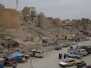 Pedestrians walk past a section of the old city in Ghazni province. (AFP/Rahmatullah Alizad)