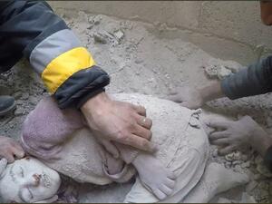 The body of a Syrian child is pulled out from the rubble following an airstrike in Eastern Ghouta, Syrian Civil Defense - Rif Dimushq