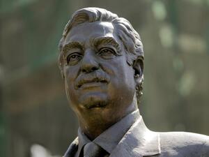 A bronze statue of slain prime minister Rafiq Hariri overlooks the site where he was killed in a massive blast in downtown Beirut. (AFP/Joseph Eid)
