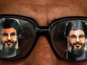 A souvenir shop owner displays glasses decorated with pictures of Hassan Nasrallah, the head of Lebanon's powerful Shiite militant group Hezbollah, in Beirut southern suburb. (AFP/File)