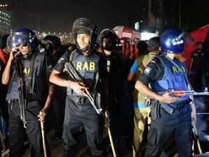 Bangladesh police inspect the crime scene as an attacker was killed in front of a police box at the entrance to Dhaka’s international airport on March 24, 2017. (AFP)