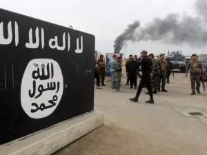 Bullet holes shown in an ISIS logo, AFP/File